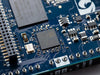 Close-up of memory chips and components on the Arduino UNO Q board.