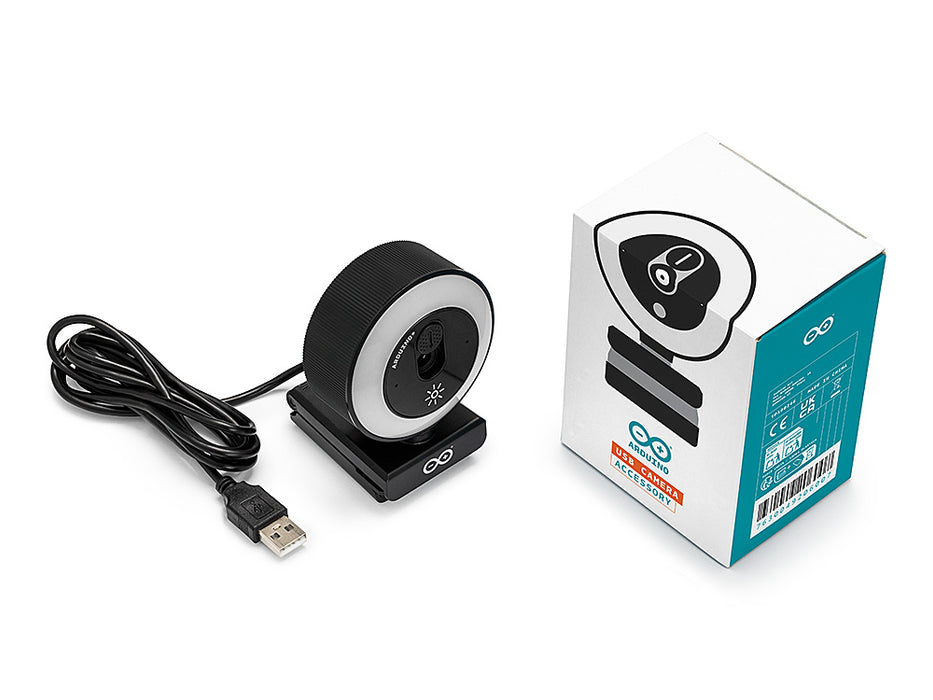 Unboxed Arduino USB Camera beside its white and teal retail box, showing the ring-light webcam on its clip stand with the USB-A cable coiled alongside.