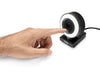 Angled view of a finger tapping the touch brightness control on the Arduino USB Camera, demonstrating the touch-dimmable LED ring light on its clip stand.