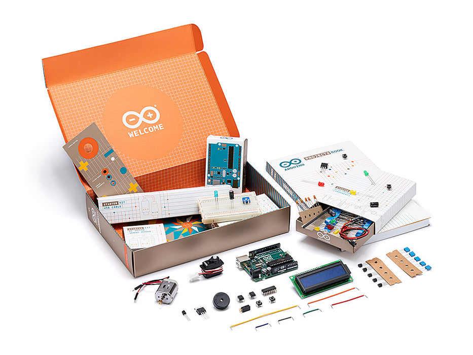 Arduino Starter Kit box with UNO board, breadboard, components, wires, and project book laid out